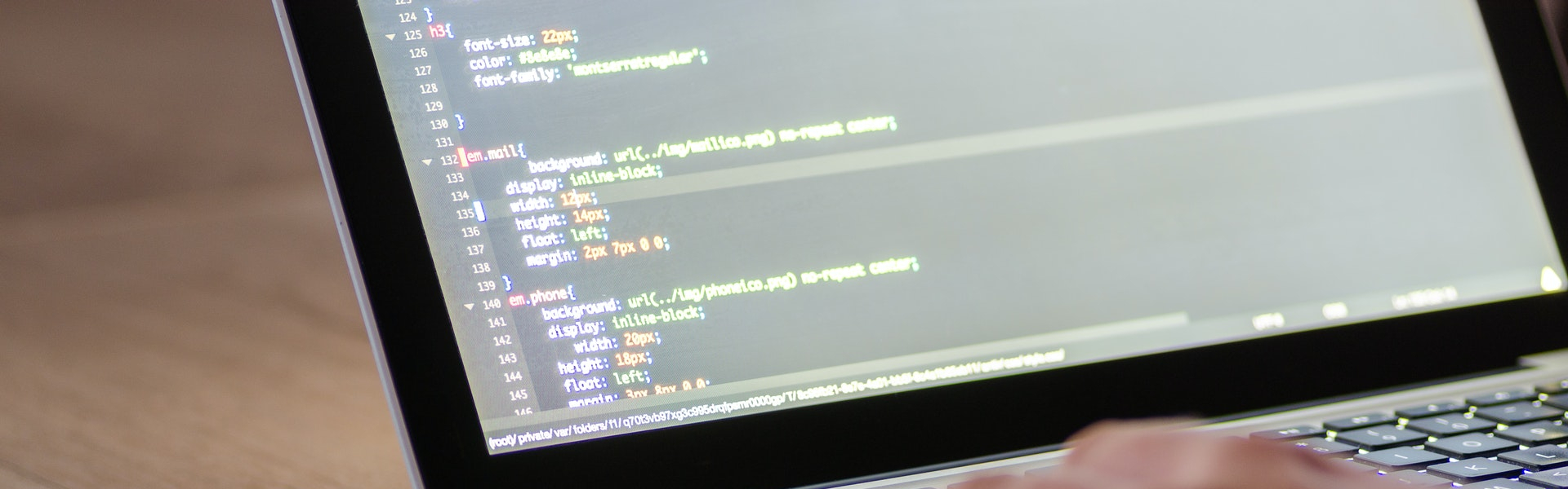 A man coding at a computer